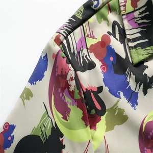 Close-up of men's ice silk shirt featuring colorful abstract graffiti and high-quality seams