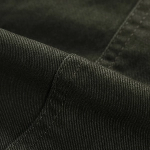 Detail of army green twill cotton fabric with reinforced double needle stitching