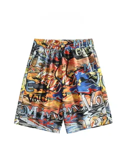 Flat lay of men's quick-dry beach shorts with vibrant graffiti print and black drawstring