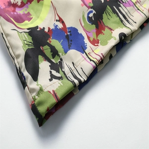 Detailed macro view of vibrant graffiti print on beige ice silk fabric shirt