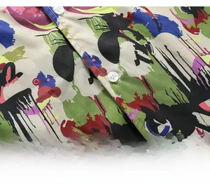 Close-up of abstract graffiti print on men's shirt with small white buttons
