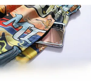 Detail shot of cargo pocket on printed beach shorts showing depth with a smartphone