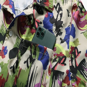 Detail of artistic graffiti print men's short sleeve shirt with functional chest pocket