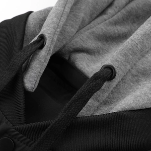 Detail of hooded jacket neckline with black ribbed trim and grey marl fabric texture