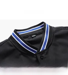 Detail view of a black baseball jacket collar featuring blue and white striped ribbing and size M tag