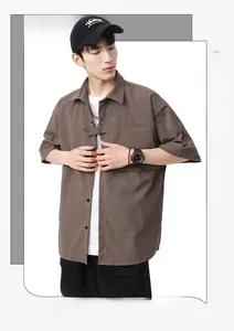 Detail view of men's loose short sleeve shirt with textured fabric and chest pocket