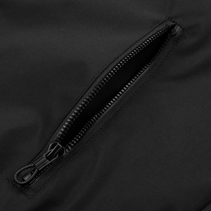 Detail of windproof black sports jacket showing functional zipper pocket and woven puller
