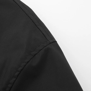 Close-up of black fabric texture with precise double stitching on casual jacket seams