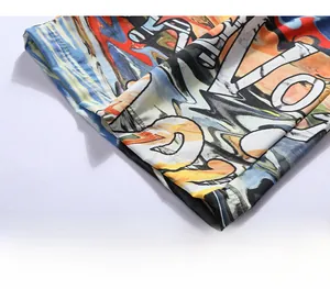 Detailed close-up of loose-fitting hem with colorful graffiti print on beach shorts