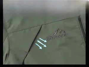 Detail shot of windproof outdoor jacket featuring mountain logo and reinforced stitching