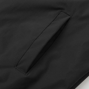 Close-up of the professional slanted welt pocket stitching on a black baseball jacket