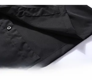 Detail of the neat bottom hem stitching and premium black fabric on the polo shirt