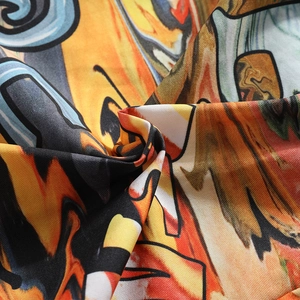Close-up detail of smooth polyester fabric with vibrant graffiti print and abstract patterns