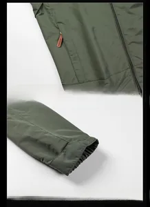 Detailed view of army green outdoor jacket featuring zipper pockets and elastic cuffs