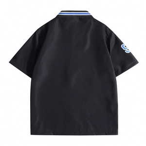 Back view of black polo shirt with striped collar and number nine print on sleeve