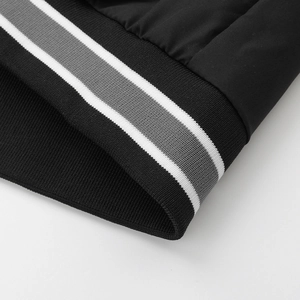 Detailed close-up of ribbed knit cuffs with white and grey stripes on a black jacket
