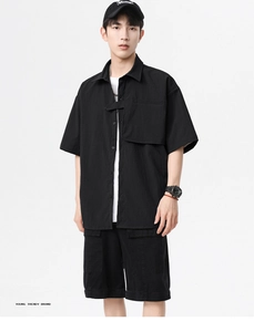 Men's black textured short sleeve shirt with oversized chest pockets in urban techwear style