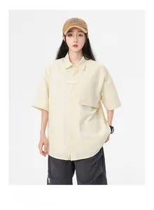 Détail d'une chemise jaune clair à manches courtes en crépon avec poche de poitrine