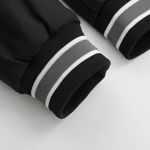 Close-up of elastic ribbed cuffs with grey and white stripes on a black jacket