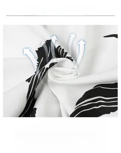 Detail showing breathable white fabric with black leaf print and soft woven texture