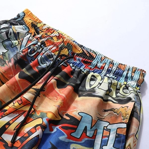 Detail of elastic waistband and black drawstring on graffiti printed beach shorts