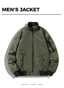 Close-up of olive green bomber jacket featuring rib-knit cuffs and zipper sleeve pocket