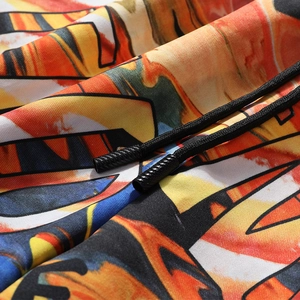 Close-up of vibrant graffiti print fabric with black drawstring and non-slip tip details