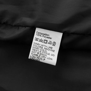 Detailed laundry label of a casual baseball jacket showing 100% polyester composition