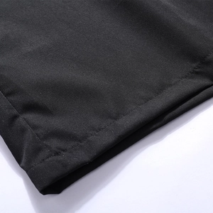 Macro detail of high-quality stitching on black polo shirt sleeve with fine fabric texture