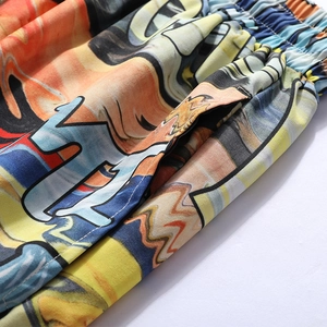 Detail of elastic waistband and side pocket on colorful graffiti print summer beach shorts