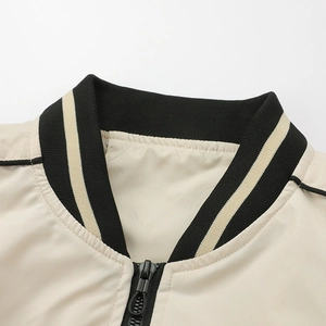 Close-up of ribbed baseball collar and metal zipper on beige bomber jacket