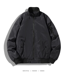 Detailed view of black bomber jacket featuring ribbed cuffs and sleeve zipper pocket