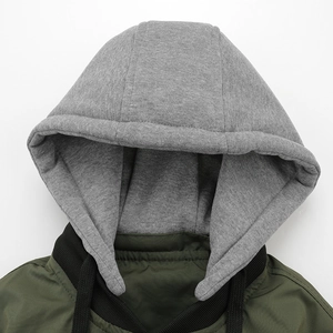 Detailed close-up of detachable hood with drawstring and ribbed collar on baseball jacket