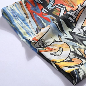 Detail of colorful graffiti print and double-stitched hem on men's beach shorts