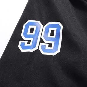 Close-up of number 99 print on black breathable polo shirt with textured fabric