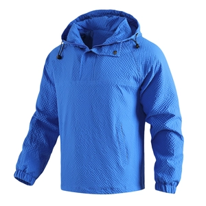 Detail of royal blue hooded jacket featuring honeycomb texture and drawstring hood