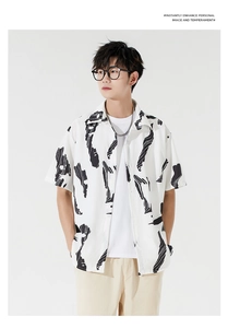 Close-up of men's loose fit short sleeve shirt with black abstract ink print detail