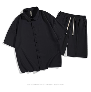 Flat lay of men's loose ice silk set featuring black short sleeve shirt and drawstring shorts