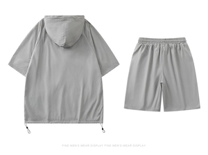 Detail of grey techwear hooded top with breathable micro-perforations and mesh texture