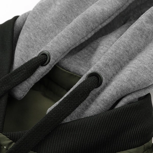 Detail of hooded jacket showing grey fabric hood, metal eyelets and thick woven drawstrings