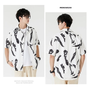 Detail view of men's loose fit short sleeve shirt with abstract black ink texture print