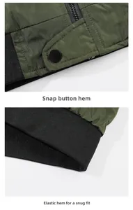 Detailed view of army green bomber jacket with black metal zipper and ribbed elastic hem