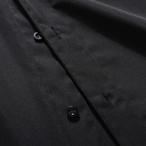 Macro detail of the polo shirt placket featuring four-hole buttons and neat stitching