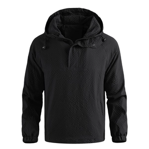 Detail of black hooded jacket featuring a unique textured 3D geometric grid fabric