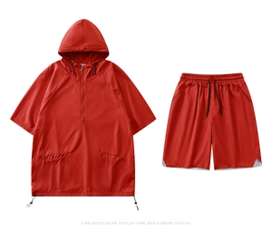 Detail of red quick-dry hooded top and matching shorts with breathable mesh lining