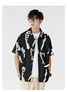 Close-up of black short sleeve Hawaiian shirt featuring white abstract ink pattern prints