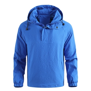 Detailed macro view of bright blue hoodie featuring small waffle grid texture and drawstring hood