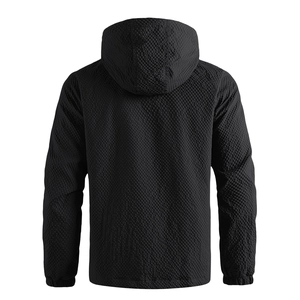 Detail of men's hooded jacket featuring black windproof fabric with honeycomb texture