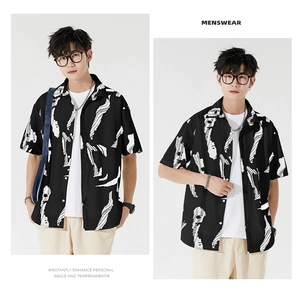 Detail of men's short sleeve shirt with black and white abstract print and button collar