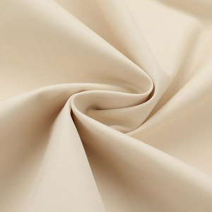Macro shot of high-quality beige canvas fabric showing dense weave and smooth texture